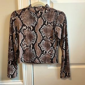 Brand new Olivia Rae long sleeve snack skin top in size Medium